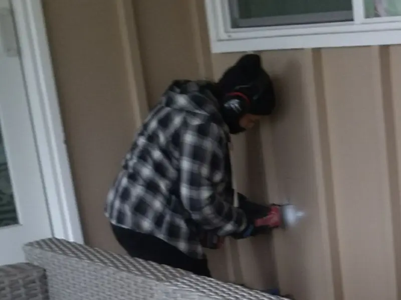 Professional electrician installing an exterior outlet in Columbine