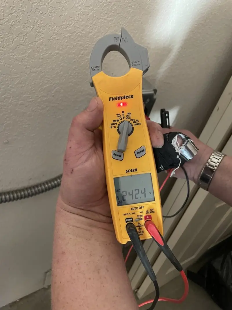 Voltage testing with clamp meter during Recessed Lighting Installation in Columbine